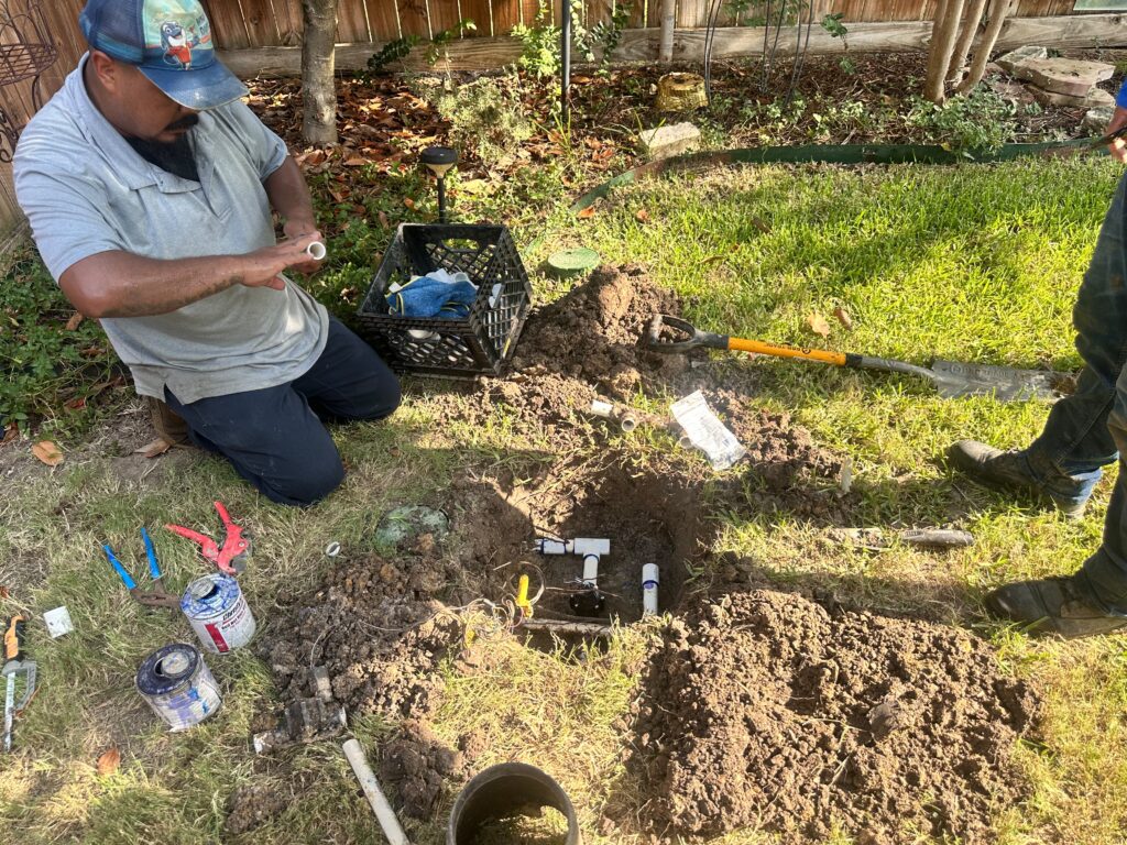 Whale Done technician repairing a residential lawn sprinkler system in McKinney, Texas.