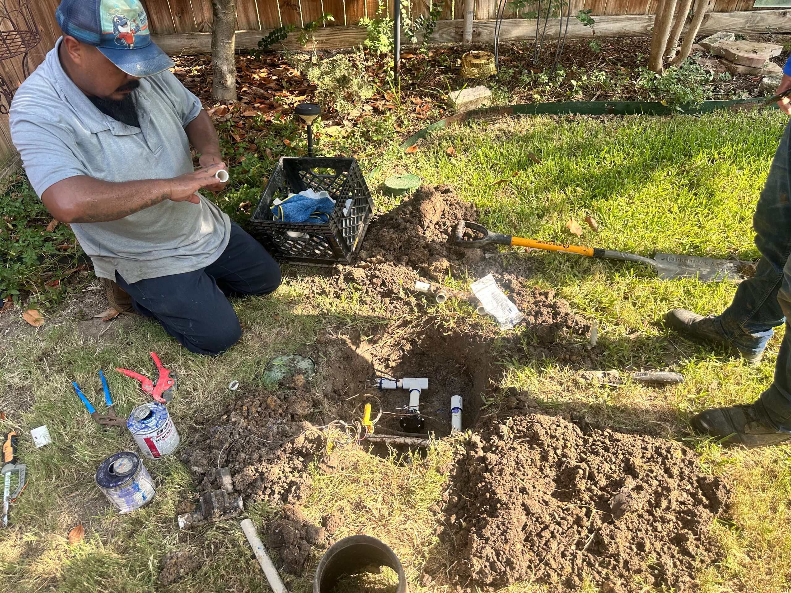 Whale Done technician repairing a residential lawn sprinkler system in McKinney, Texas.